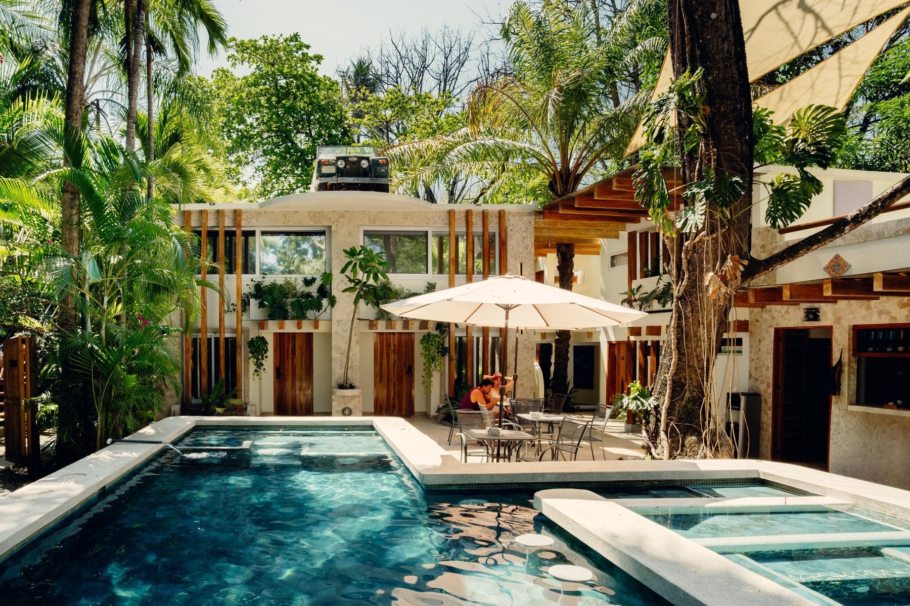 Water and tropical shade through the garden